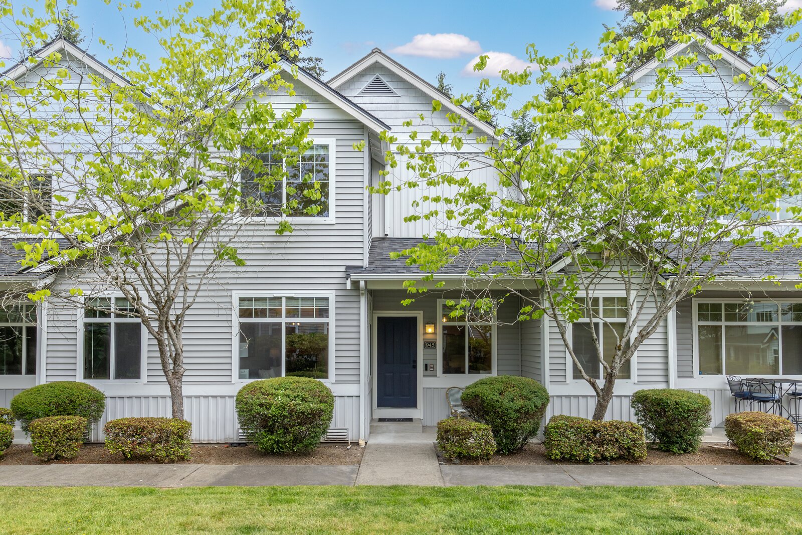 Front exterior of the townhome with a navy front door