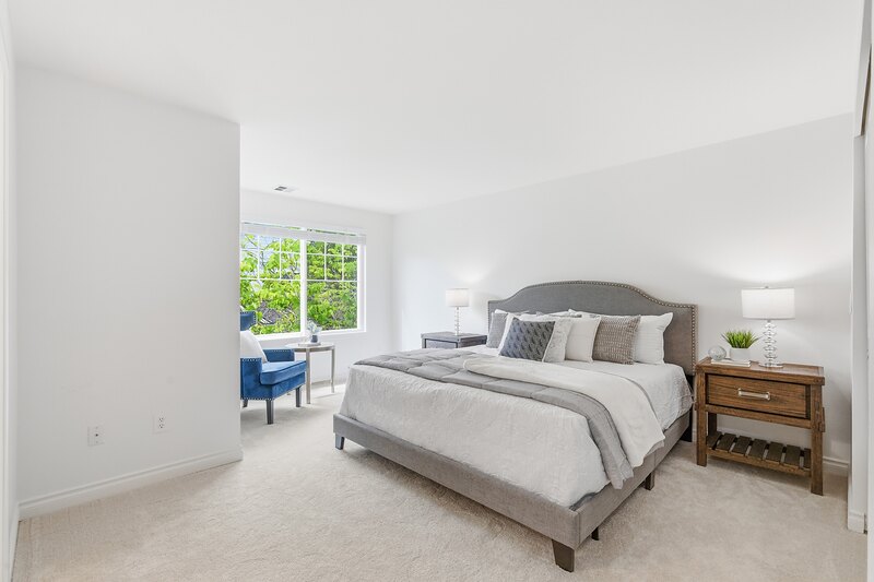 Primary bedroom with light carpet